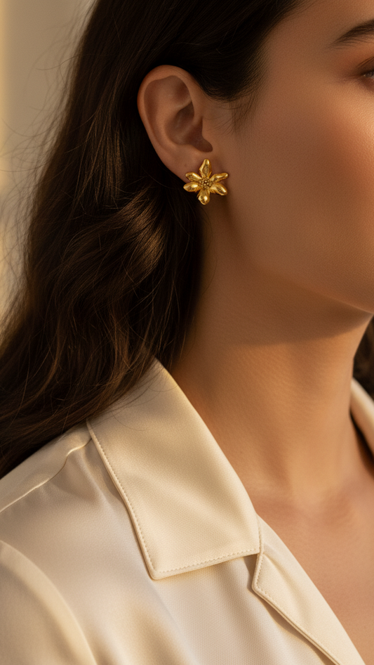 Close-up of a woman wearing gold earrings with a blurred background